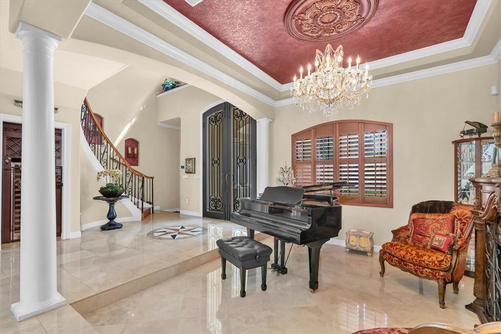 2861 Roehampton Close Tarpon Springs, FL 34688 - Photo 8 of 79 a living room with furniture and a chandelier