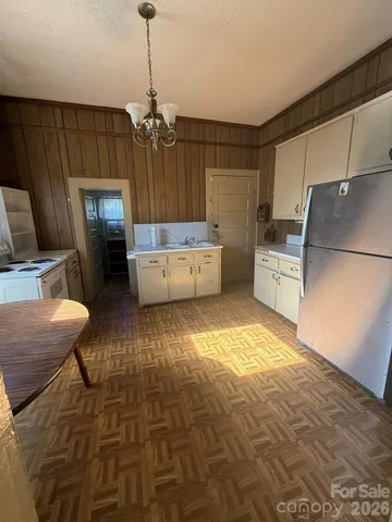 a kitchen with a refrigerator and a stove