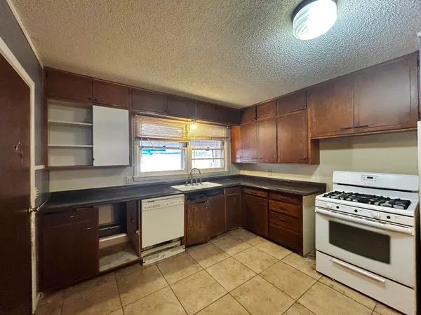 a kitchen with stainless steel appliances granite countertop a stove and a sink
