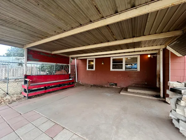 a view of backyard with wooden deck and furniture
