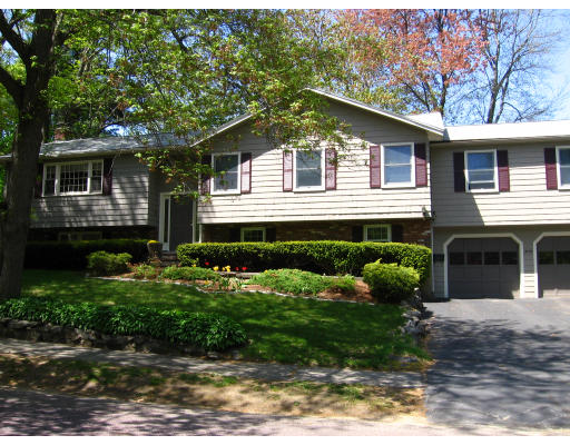 20 Sherwood Road Reading, MA 01867 - Photo 4 of 18 a front view of a house with a yard