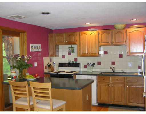 20 Sherwood Road Reading, MA 01867 - Photo 10 of 18 a kitchen with stainless steel appliances granite countertop a sink and cabinets