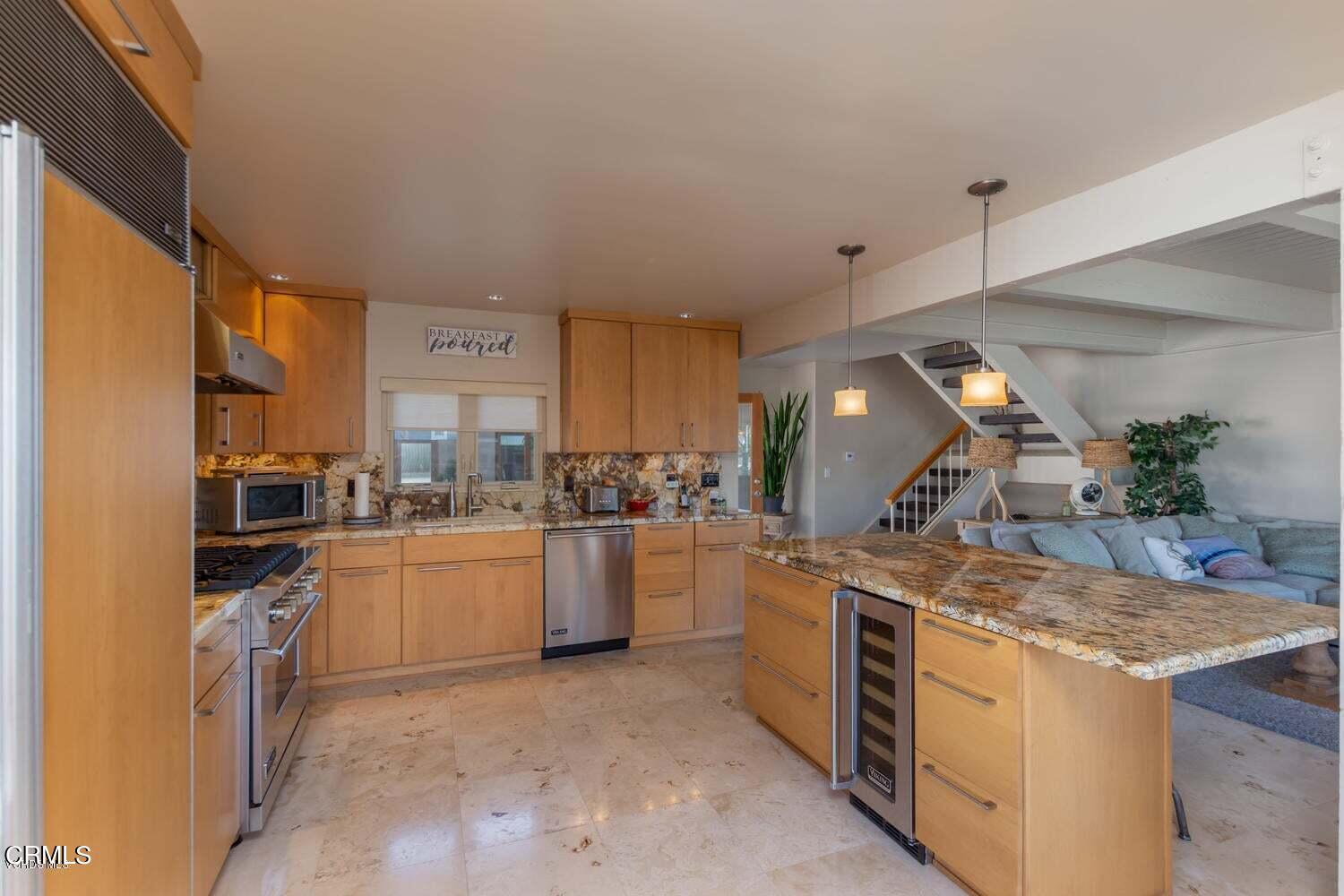4435 Costa De Oro Oxnard, CA 93035 - Photo 11 of 50 a kitchen with a stove and a refrigerator