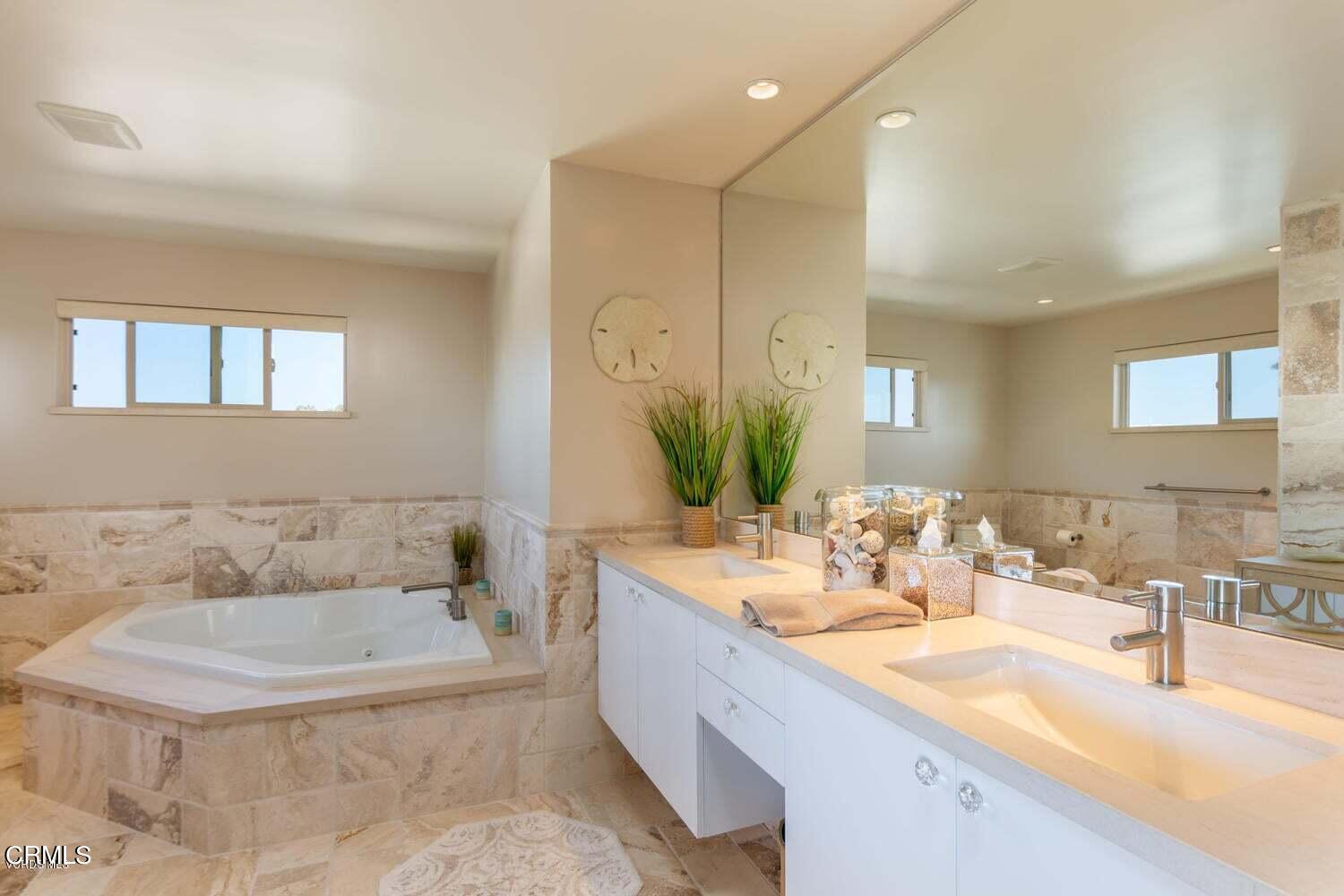 4435 Costa De Oro Oxnard, CA 93035 - Photo 22 of 50 a bathroom with a tub sink and mirror