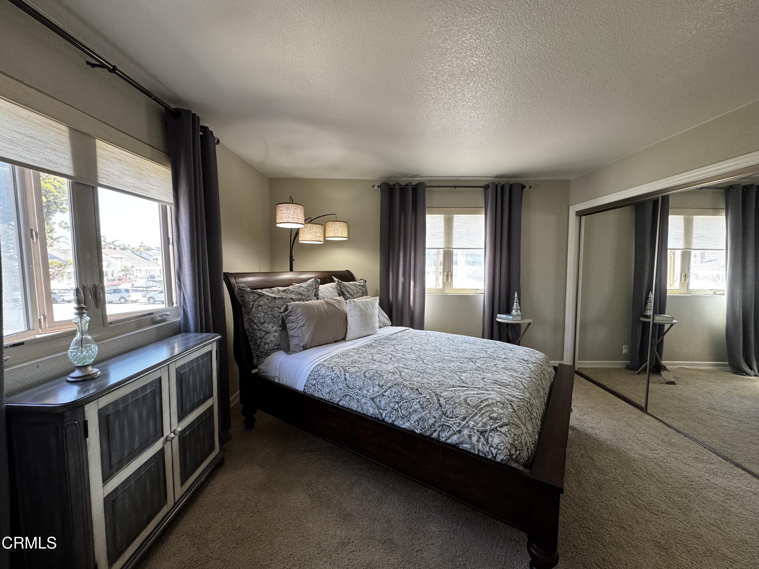 4435 Costa De Oro Oxnard, CA 93035 - Photo 27 of 50 a bedroom with a bed and large windows