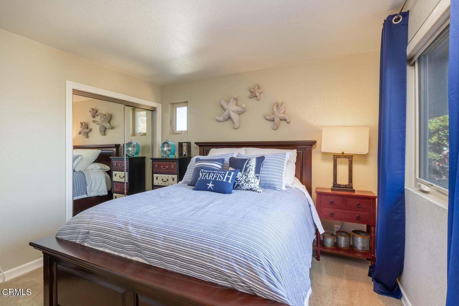 4435 Costa De Oro Oxnard, CA 93035 - Photo 29 of 50 a bedroom with a large bed and a chandelier