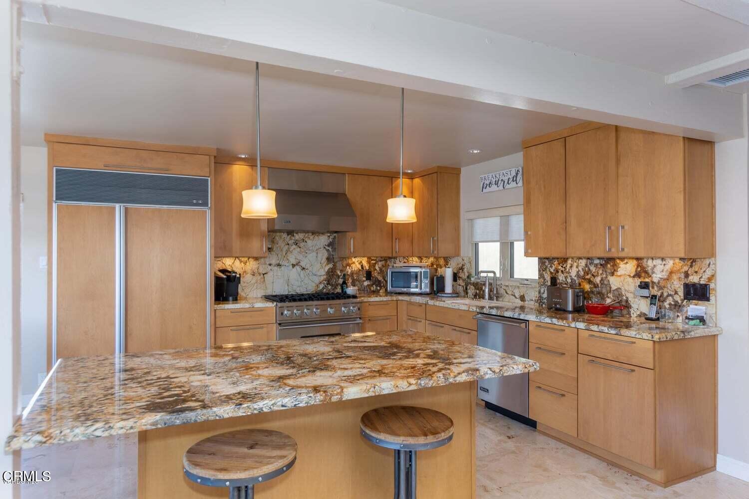 4435 Costa De Oro Oxnard, CA 93035 - Photo 9 of 50 a kitchen with kitchen island granite countertop a sink and a refrigerator