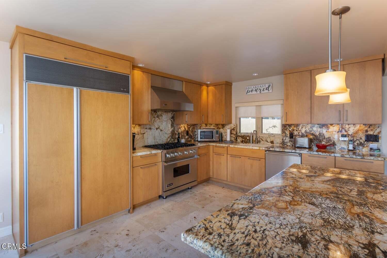 4435 Costa De Oro Oxnard, CA 93035 - Photo 10 of 50 a kitchen with stainless steel appliances granite countertop a refrigerator a stove and a sink with cabinets