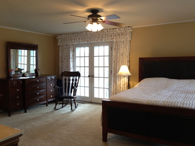 32730 Pleasant Hill Road Genoa, IL 60135 - Photo 10 of 23 a bedroom with a bed and a chandelier