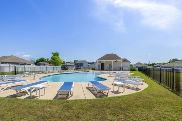 a view of a swimming pool with a lounge chairs