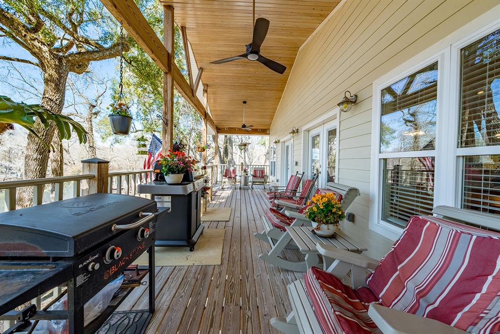 498 Southwest Manatee Terrace Fort White, FL 32038 - Photo 15 of 50 a view of a patio with table and chairs potted plants with wooden floor