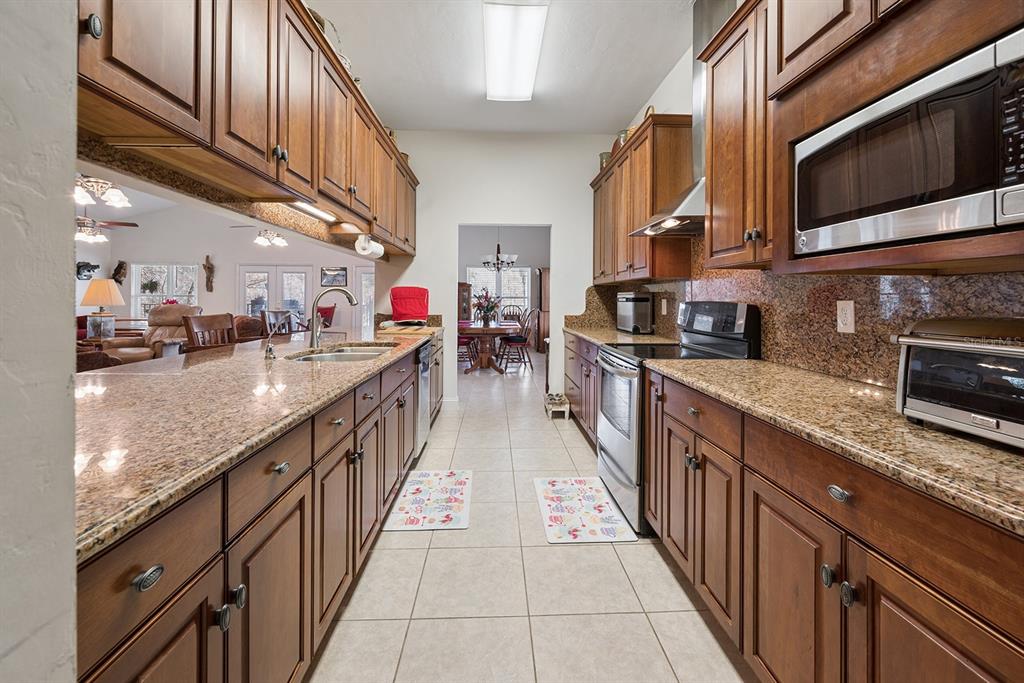 498 Southwest Manatee Terrace Fort White, FL 32038 - Photo 32 of 50 a kitchen with stainless steel appliances granite countertop lots of counter top space
