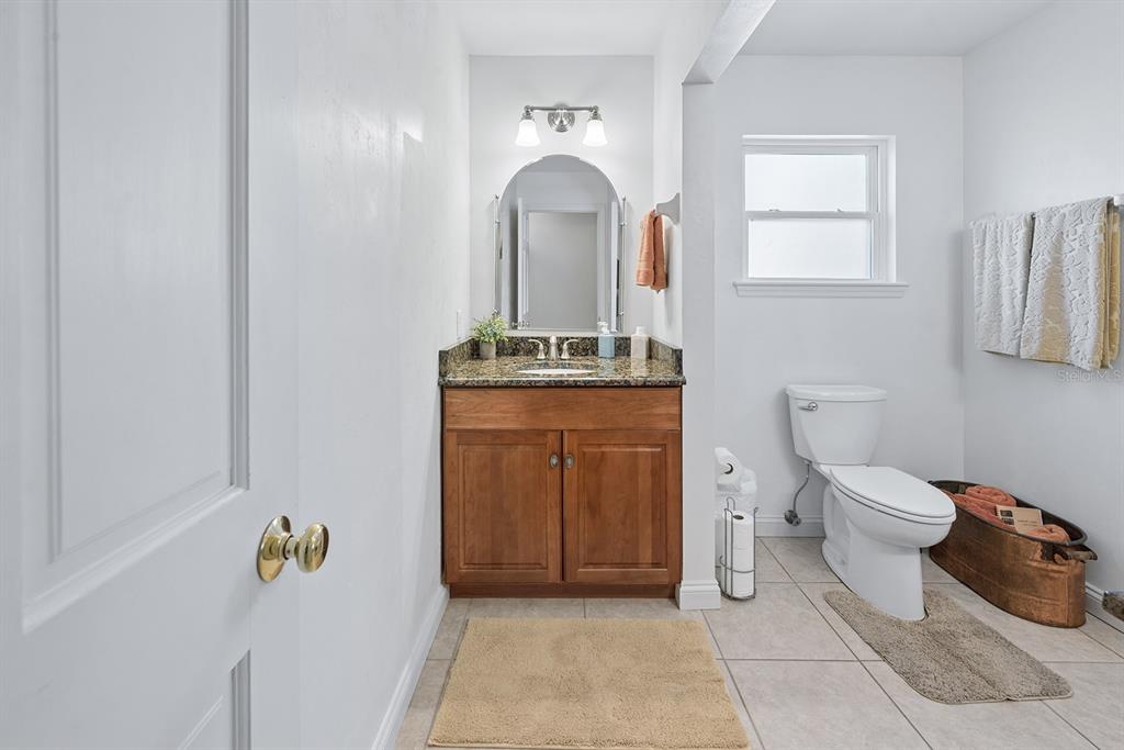 498 Southwest Manatee Terrace Fort White, FL 32038 - Photo 39 of 50 a bathroom with a toilet a sink and mirror