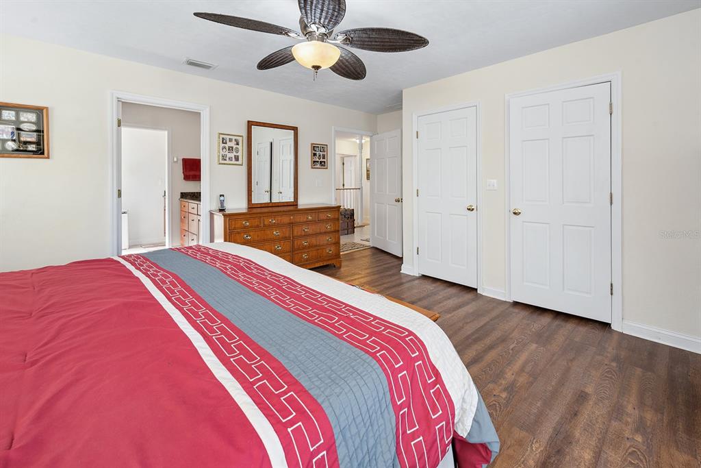 498 Southwest Manatee Terrace Fort White, FL 32038 - Photo 41 of 50 a bedroom with a bed and a chandelier