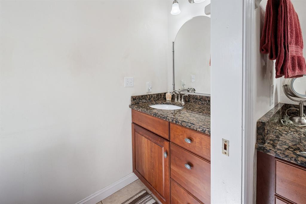498 Southwest Manatee Terrace Fort White, FL 32038 - Photo 44 of 50 a bathroom with a granite countertop sink and a mirror
