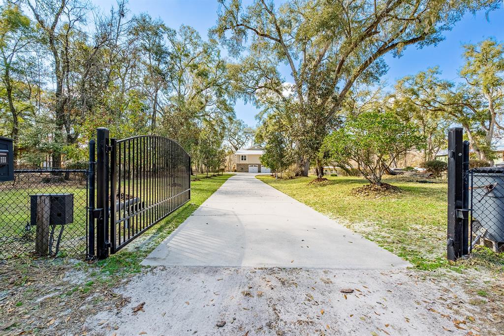 498 Southwest Manatee Terrace Fort White, FL 32038 - Photo 5 of 50 a view of a yard with large trees