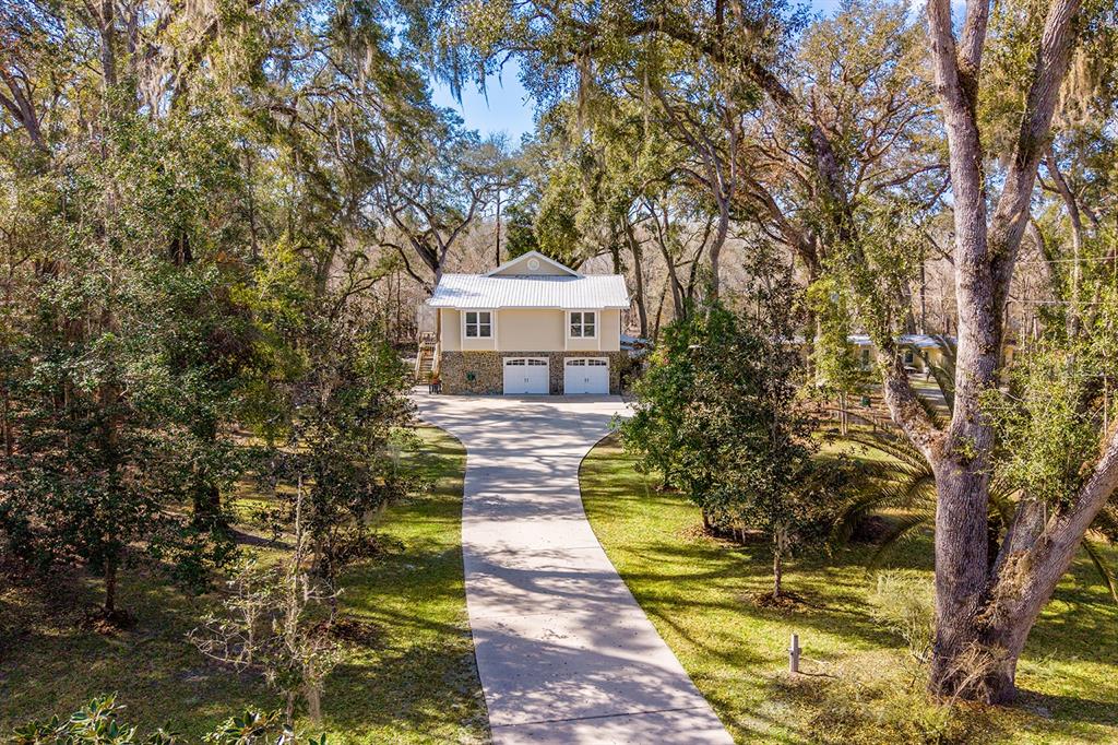 498 Southwest Manatee Terrace Fort White, FL 32038 - Photo 6 of 50 a front view of a house with a yard