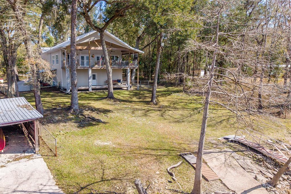 498 Southwest Manatee Terrace Fort White, FL 32038 - Photo 10 of 50 a view of a house with swimming pool and sitting area