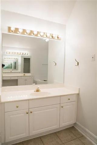 a bathroom with a sink and mirror