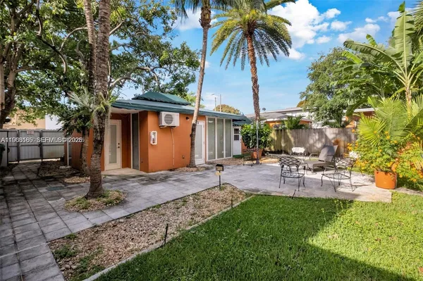 a view of a backyard with a sitting area and furniture