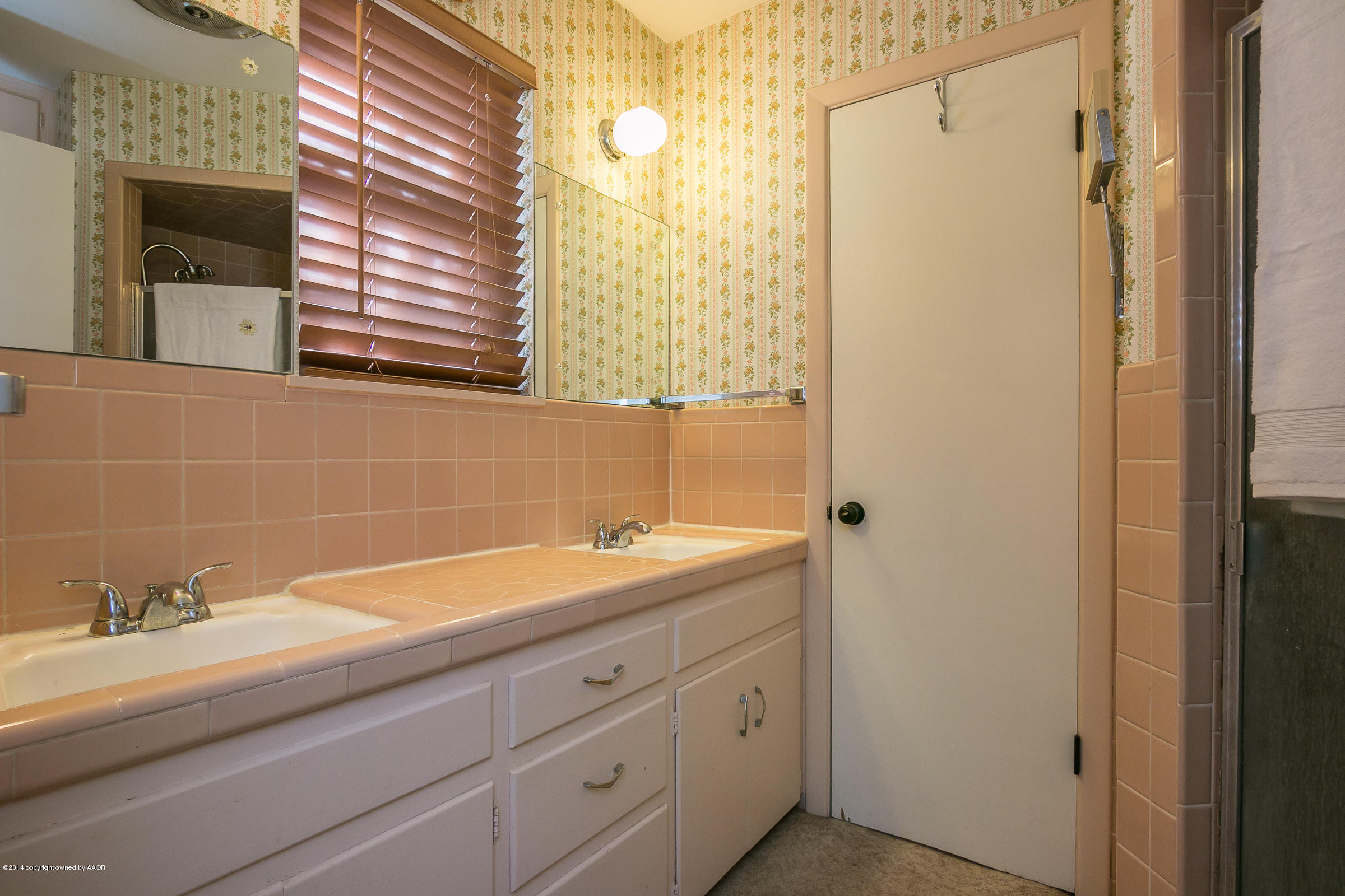 6009 Dreyfuss Road Amarillo, TX 79106 - Photo 14 of 23 a bathroom with a granite countertop sink and a mirror