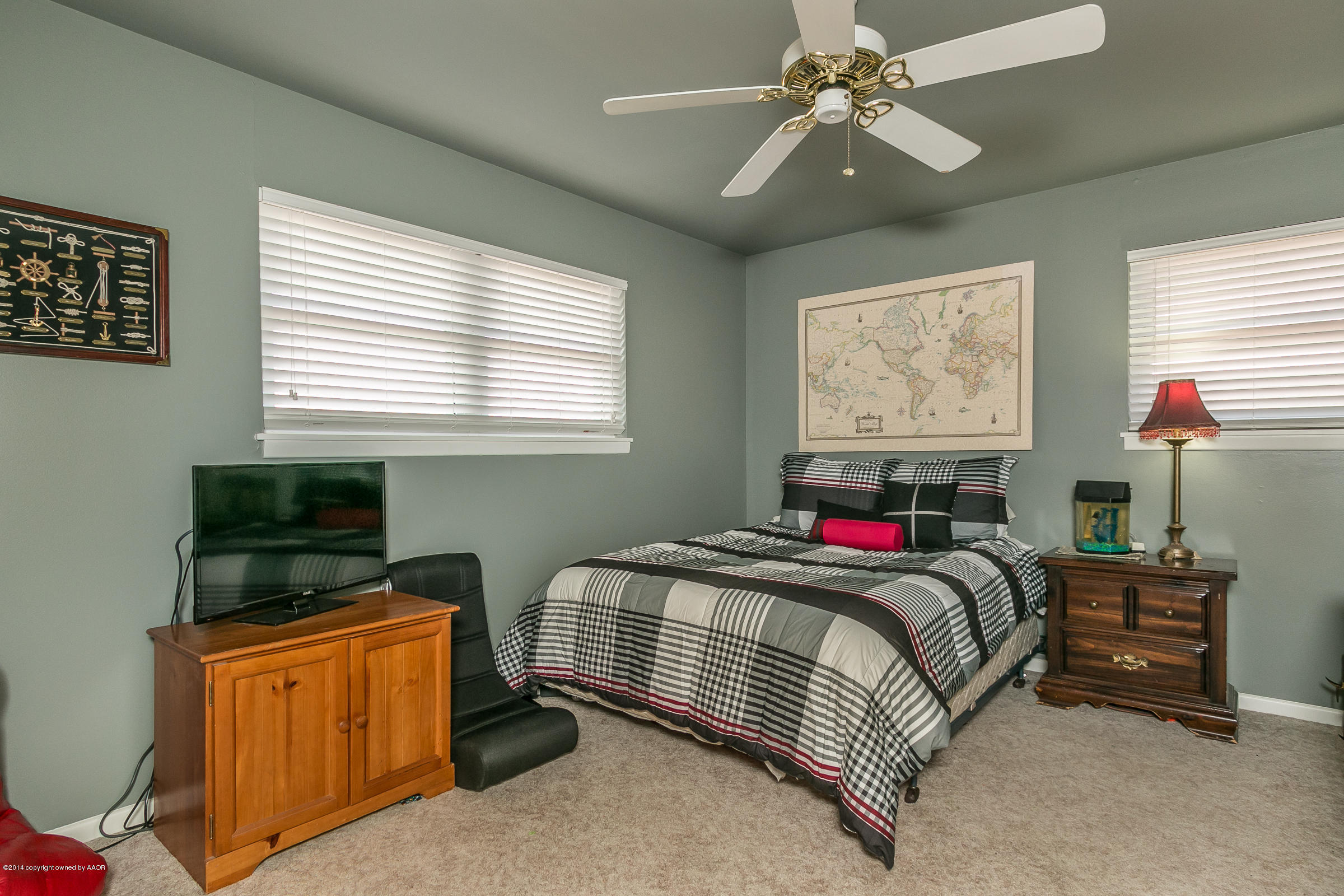 6009 Dreyfuss Road Amarillo, TX 79106 - Photo 15 of 23 a bedroom with a bed and a chandelier