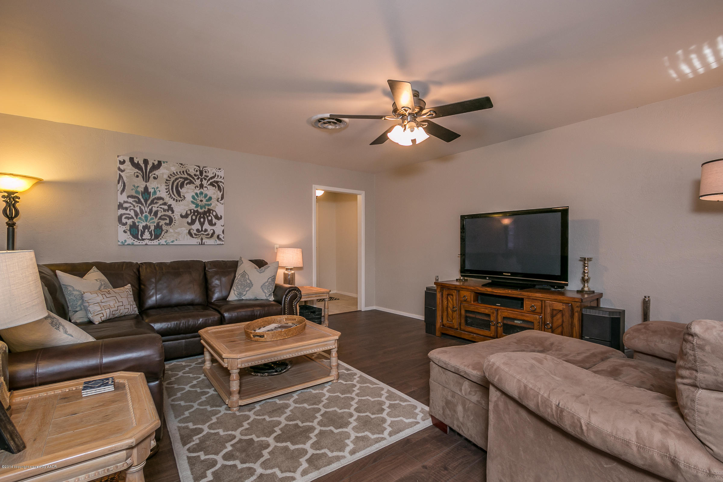 6009 Dreyfuss Road Amarillo, TX 79106 - Photo 4 of 23 a living room with furniture and a flat screen tv