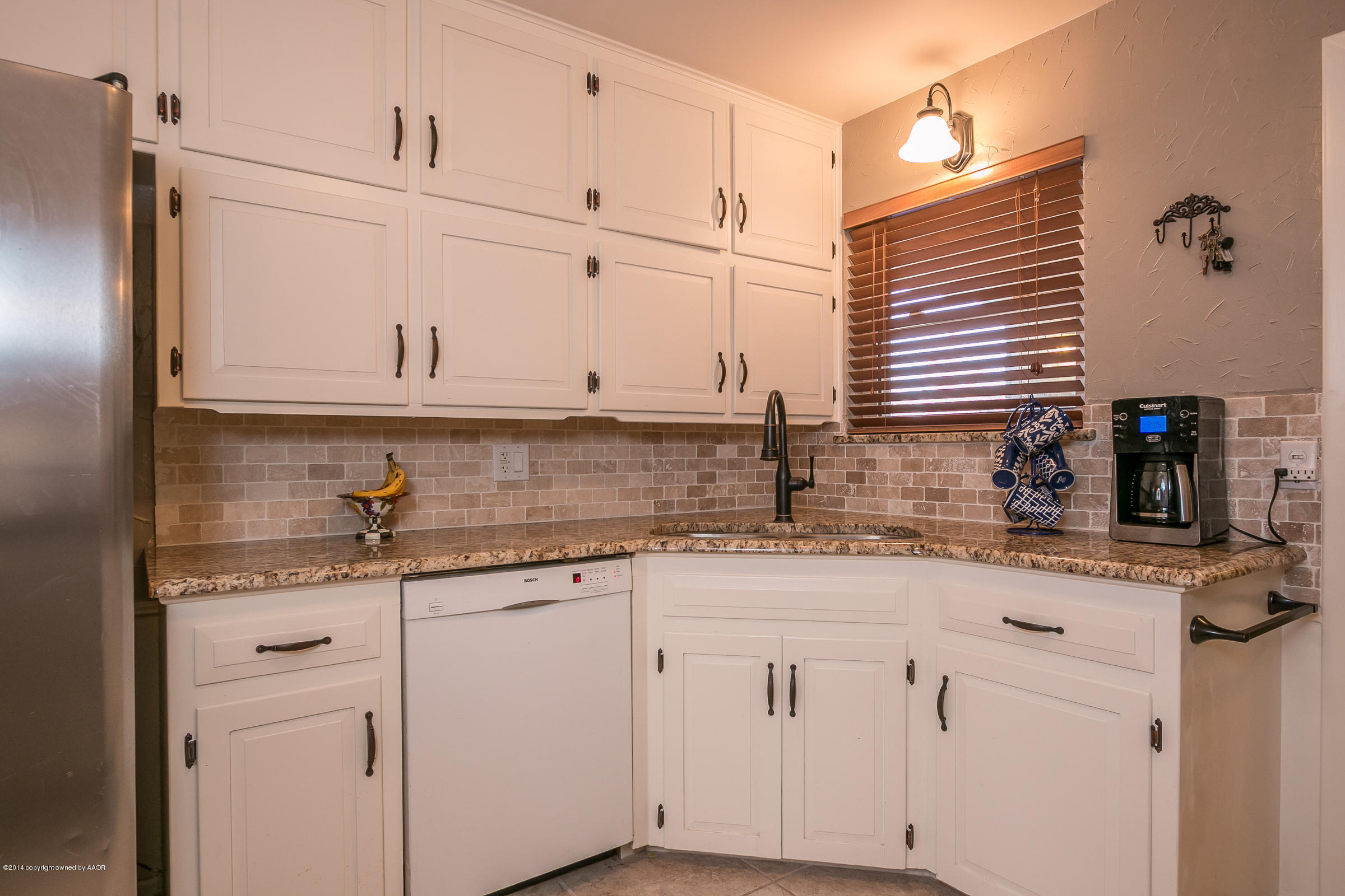 6009 Dreyfuss Road Amarillo, TX 79106 - Photo 7 of 23 a kitchen with stainless steel appliances granite countertop white cabinets sink and dishwasher