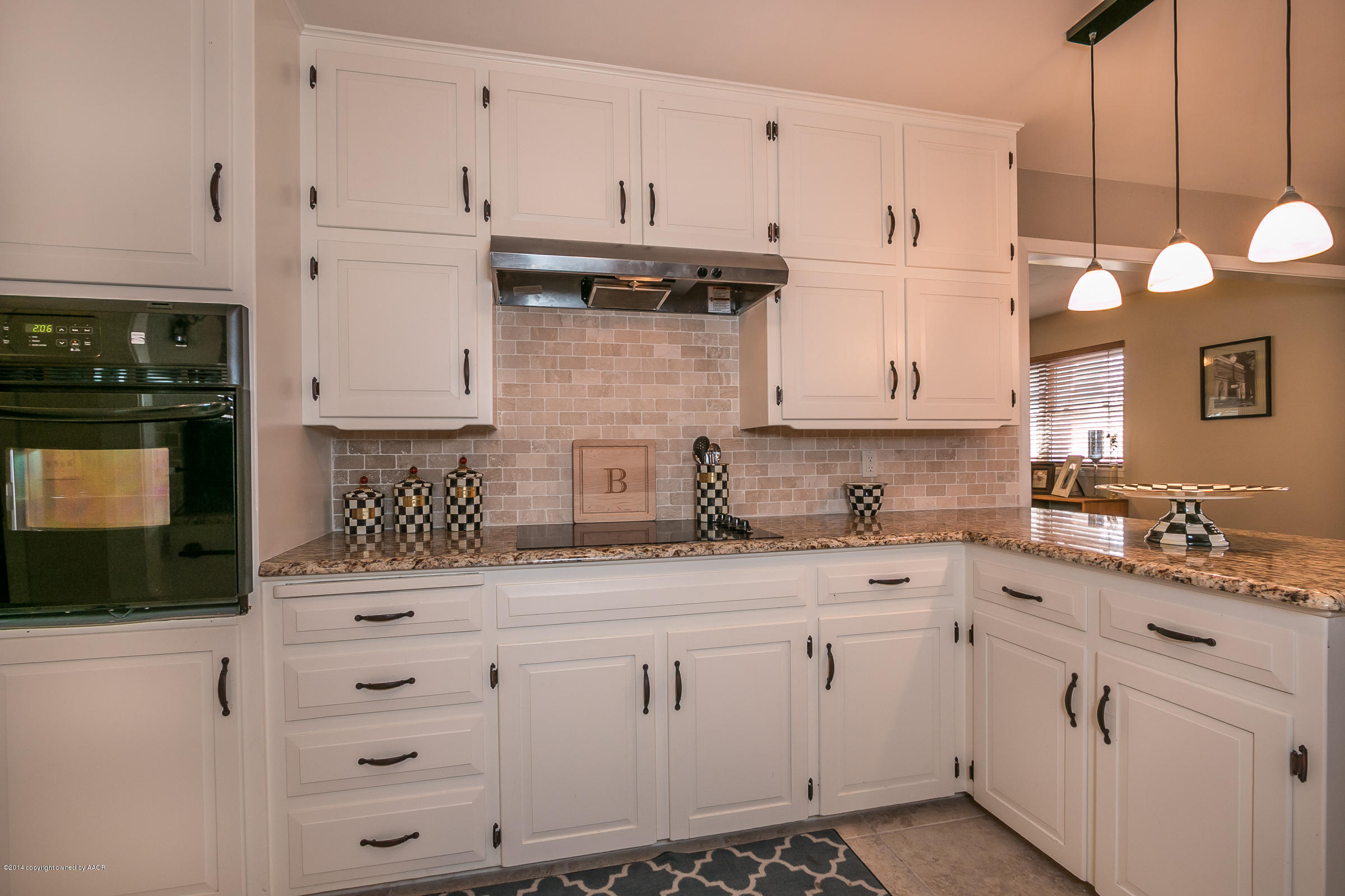 6009 Dreyfuss Road Amarillo, TX 79106 - Photo 8 of 23 a kitchen with white cabinets and white appliances