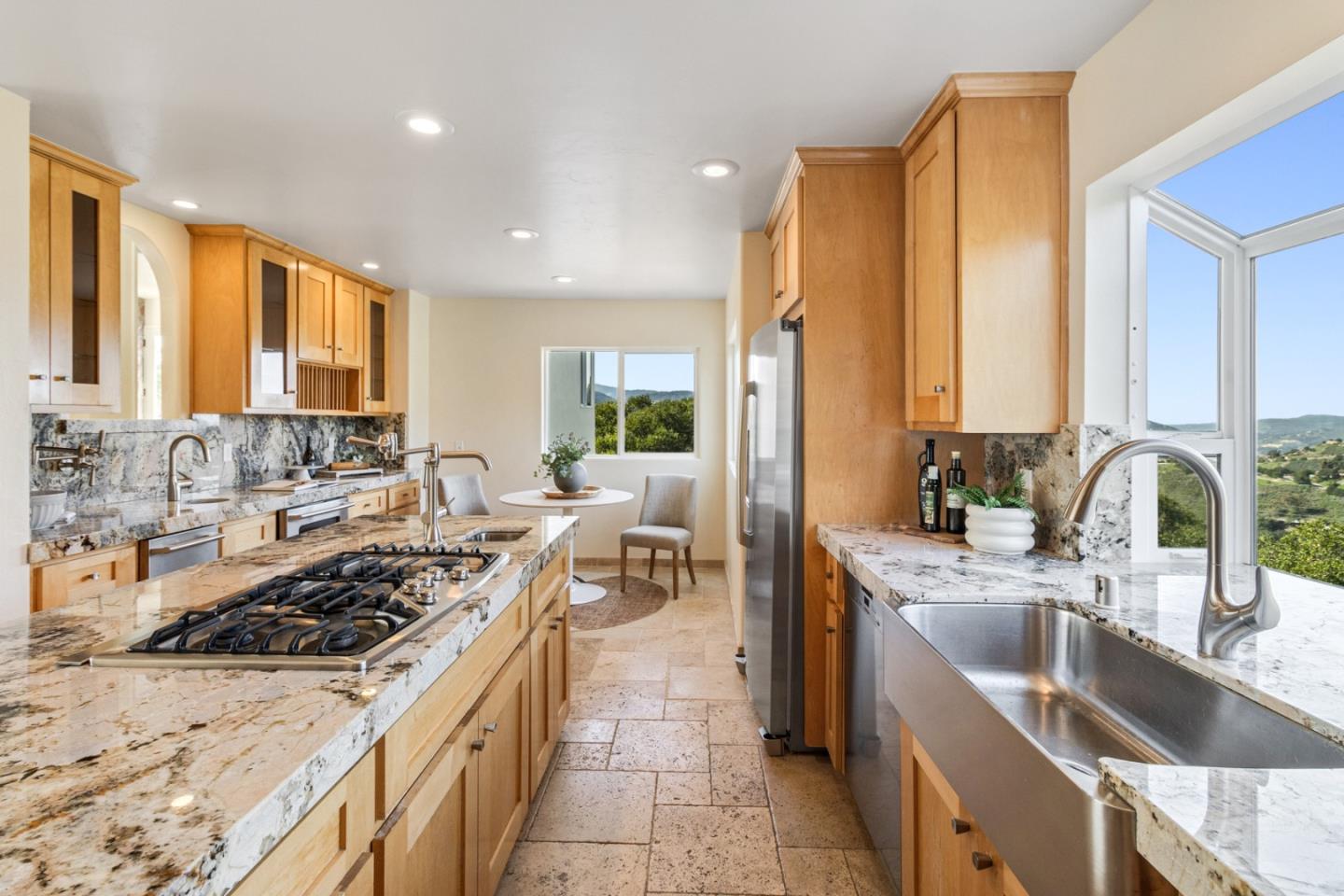 320 El Caminito Road Carmel Valley, CA 93924 - Photo 19 of 62 a kitchen with stainless steel appliances a sink stove and cabinets