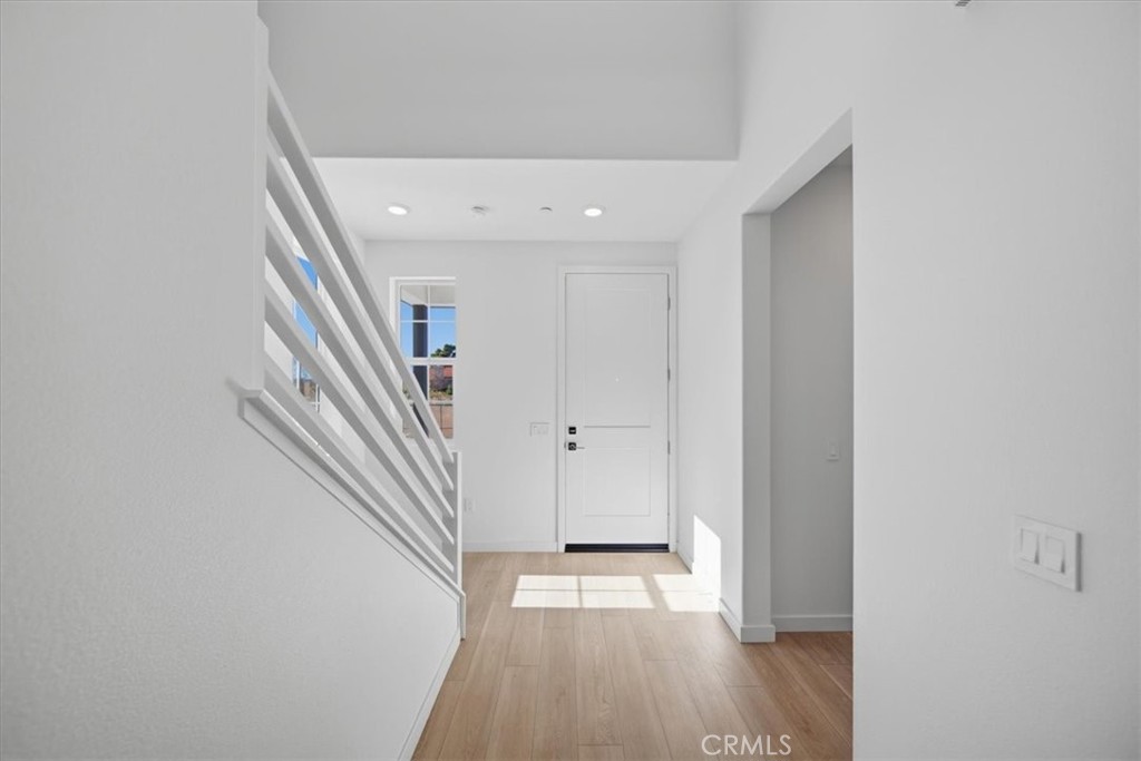 4801 Arroyo Run Moorpark, CA 93021 - Photo 3 of 27 a view of a hallway with wooden floor and staircase
