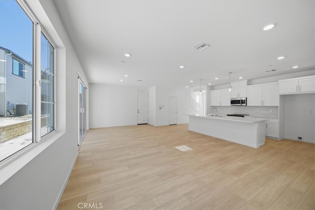 4801 Arroyo Run Moorpark, CA 93021 - Photo 4 of 27 a view of kitchen with kitchen island white cabinets and refrigerator