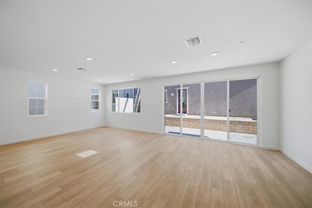 4801 Arroyo Run Moorpark, CA 93021 - Photo 5 of 27 a view of an empty room with wooden floor and a window