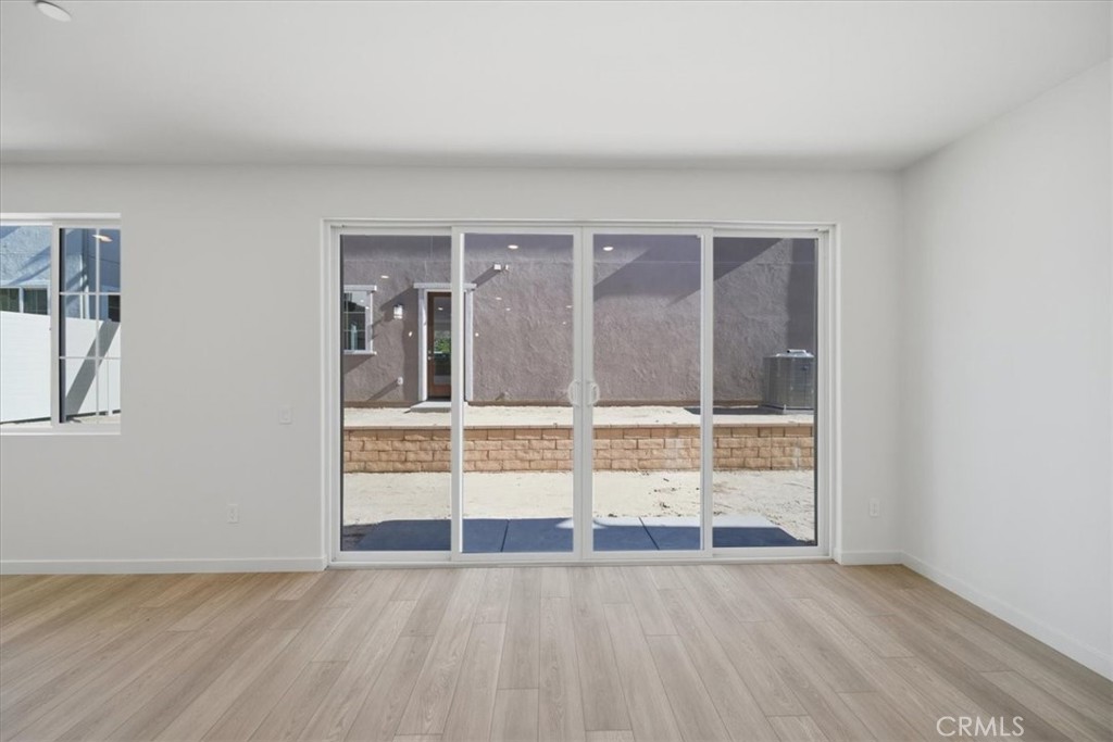 4801 Arroyo Run Moorpark, CA 93021 - Photo 8 of 27 an empty room with wooden floor and windows