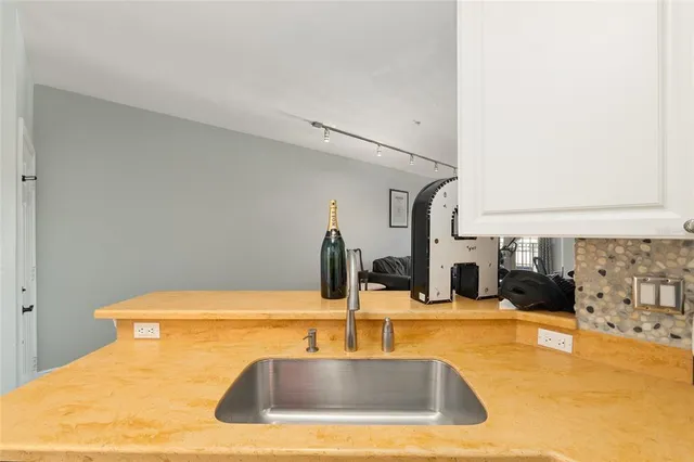 a room with a sink and a fireplace