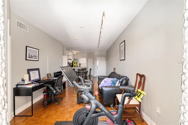 a view of a patio with dining table and chairs under an umbrella