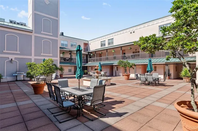a view of a building with sitting area and furniture