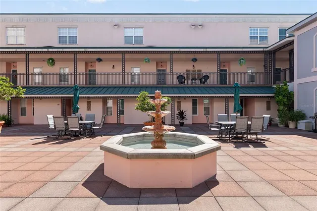a building outdoor space with patio furniture and potted plants