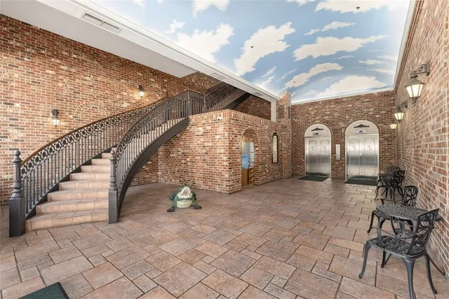 a view of a patio with table and chairs and potted plants