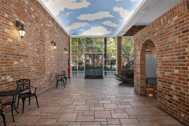 a view of a brick wall with chairs in a room