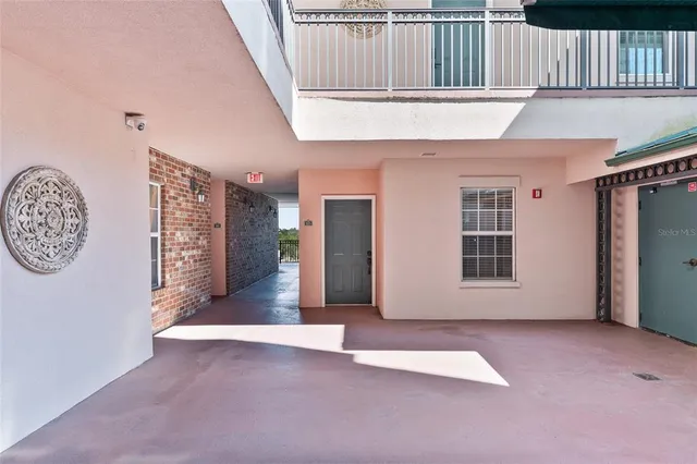 a view of a hallway with wooden floor and a living room