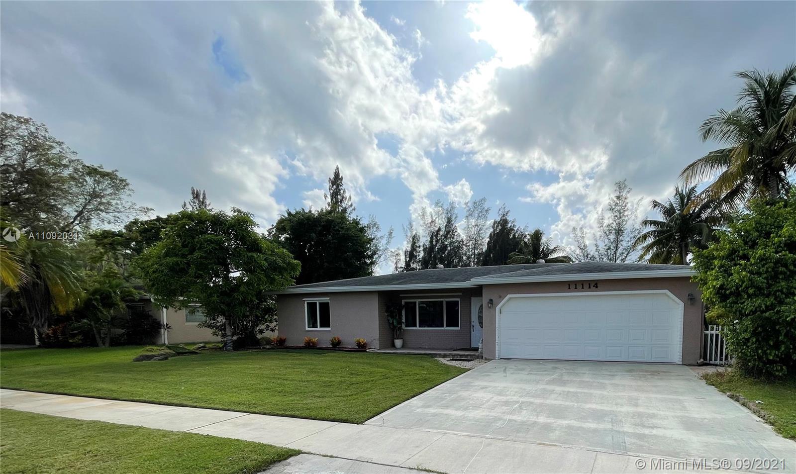 11114 Delta Circle Boca Raton, FL 33428 - Photo 1 of 15 a front view of a house with garden