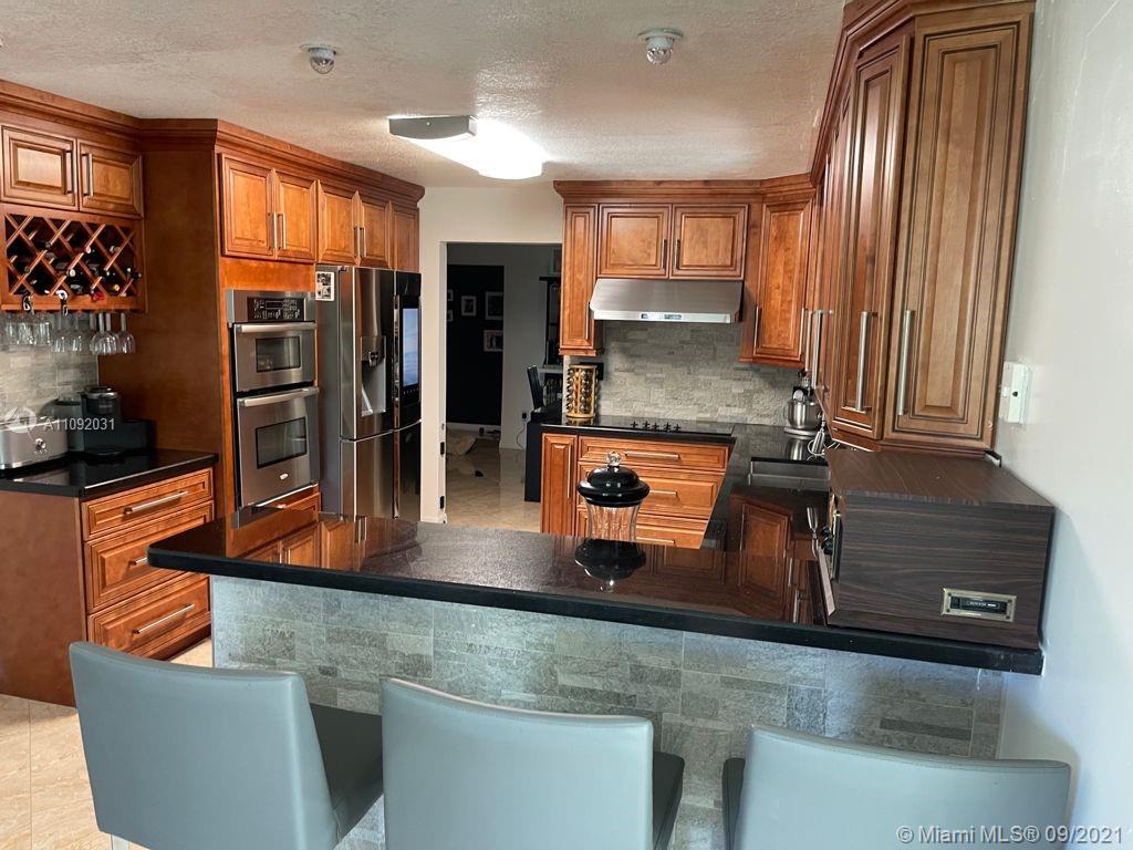 11114 Delta Circle Boca Raton, FL 33428 - Photo 2 of 15 a kitchen with stainless steel appliances granite countertop a sink and a refrigerator