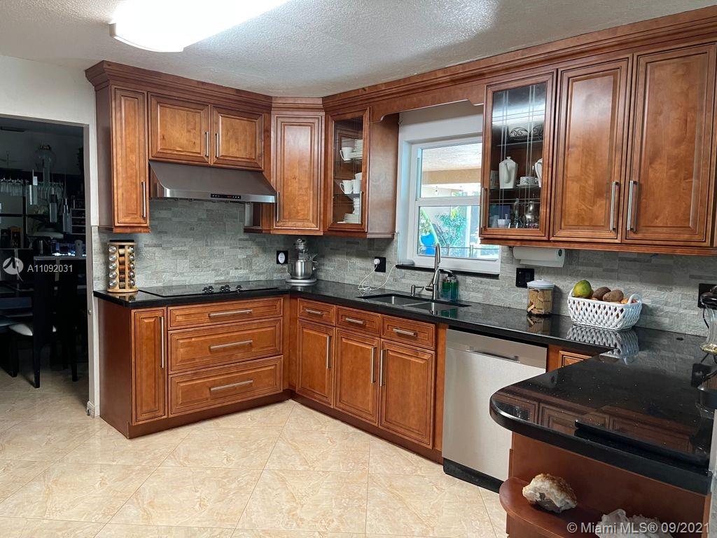11114 Delta Circle Boca Raton, FL 33428 - Photo 3 of 15 a kitchen with stainless steel appliances granite countertop a sink stove and cabinets