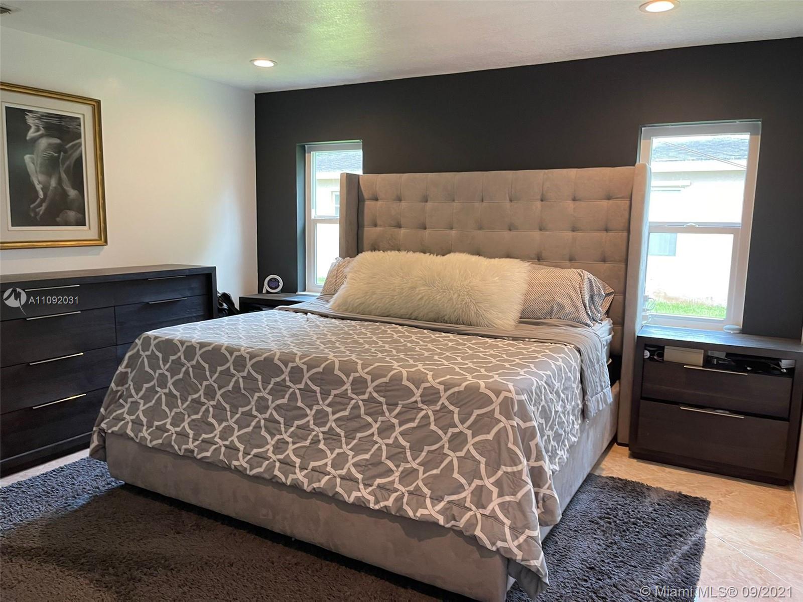 11114 Delta Circle Boca Raton, FL 33428 - Photo 4 of 15 a bedroom with a bed and a couch
