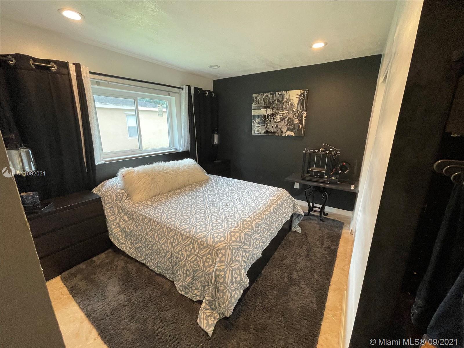 11114 Delta Circle Boca Raton, FL 33428 - Photo 6 of 15 a bed sitting in a bedroom next to a window