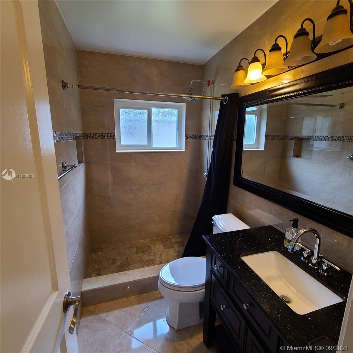 11114 Delta Circle Boca Raton, FL 33428 - Photo 10 of 15 a bathroom with a sink a toilet and shower
