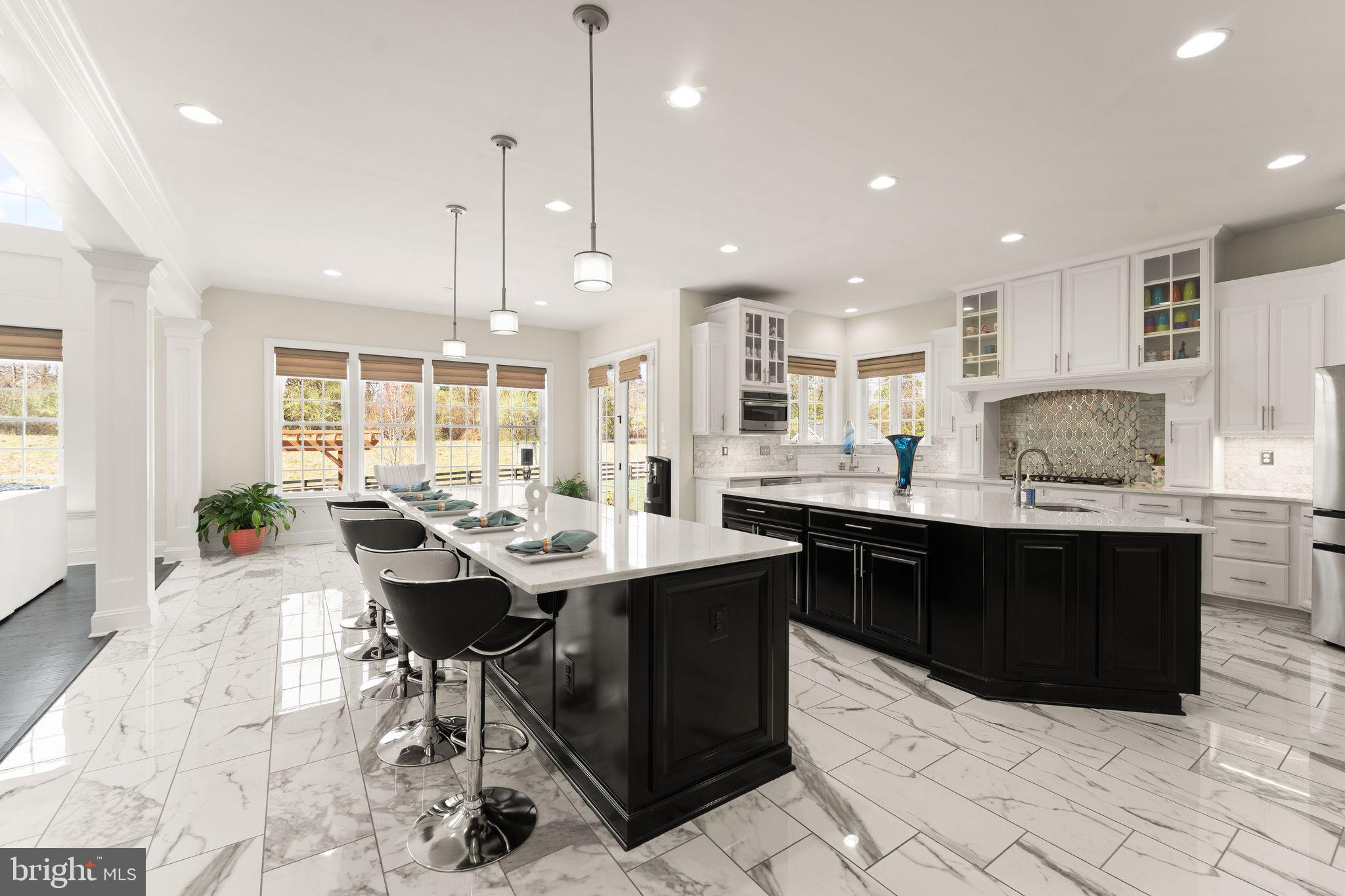 25873 Cameron Walk Place Aldie, VA 20105 - Photo 12 of 92 a large kitchen with a table and chairs