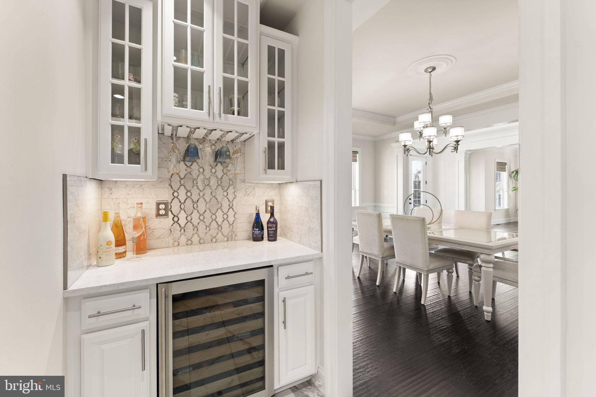 25873 Cameron Walk Place Aldie, VA 20105 - Photo 19 of 92 a view of a dining room with furniture wooden floor and chandelier