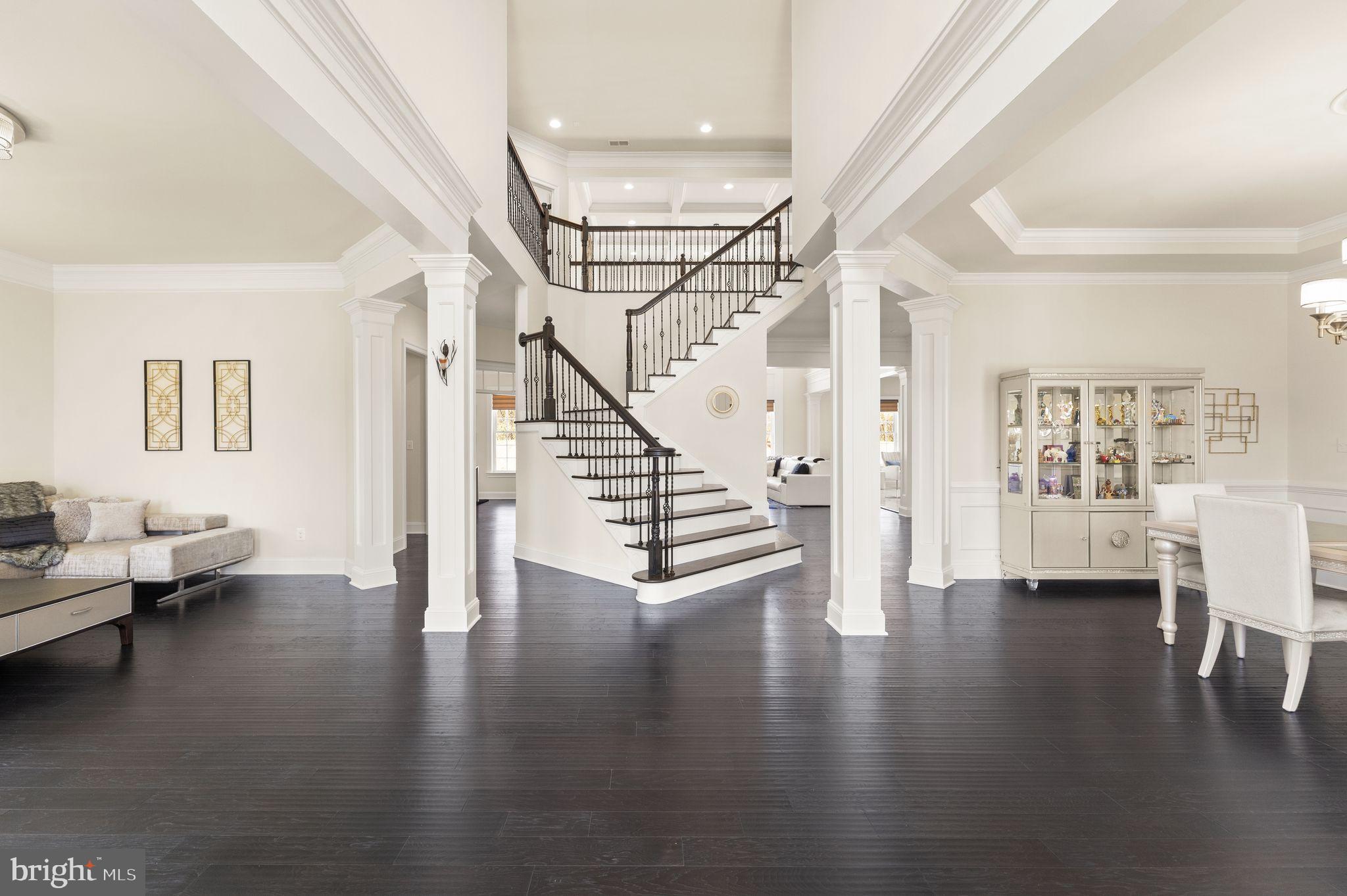 25873 Cameron Walk Place Aldie, VA 20105 - Photo 20 of 92 a view of an empty room with wooden floor and a ceiling fan